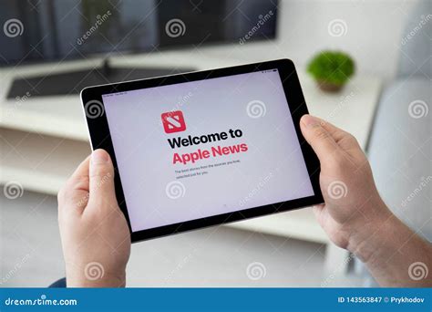 Man Holding Ipad Pro With Service Apple News On Screen Editorial