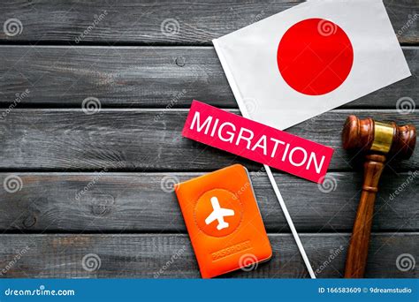 Migration To Japan Concept Japanese Flag Near Passport And Judge Hammer On Dark Wooden