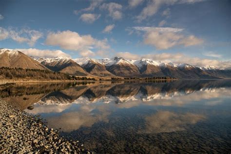 Premium Photo Snow Capped Mountain Reflections On A Still Alpine Lake