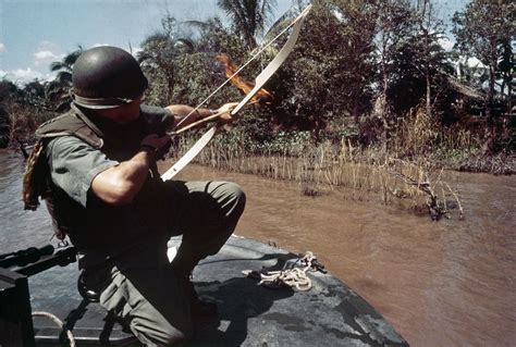 This Photo Of A Navy Officer Firing A Flaming Arrow In Vietnam Is