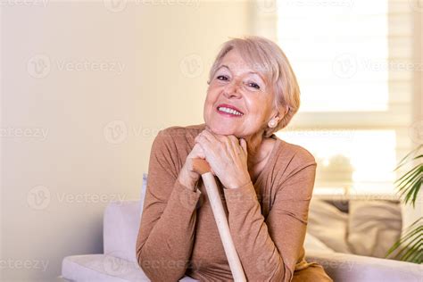 Smiling Grandmother Sitting On Couch Portrait Of A Beautiful Smiling Senior Woman With Walking