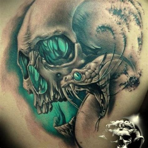 Snake with green eyed skull tattoo - Tattooimages.biz