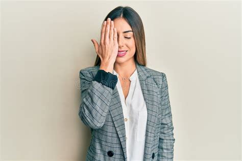 Young Hispanic Woman Wearing Business Clothes Covering One Eye With