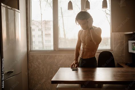 Sporty Man With Naked Torso At Home Typing A Message In A Smartphone