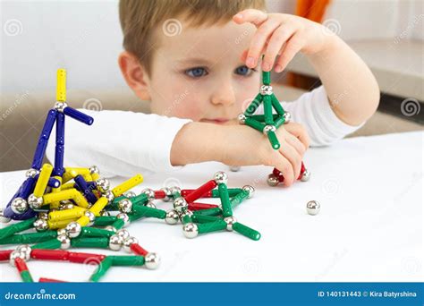 Cute Little Child Boy Playing Magnets Toy For Brain Development Fine