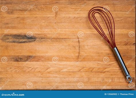 Worn Butcher Block Cutting Board With Wire Whisk Stock Photography