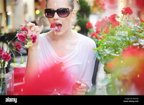 Delighted Brunette Woman Eating Sweet Strawberry Stock Photo Alamy