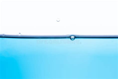 Calm Surface Of Transparent Blue Liquid With One Bubble Stock Photo