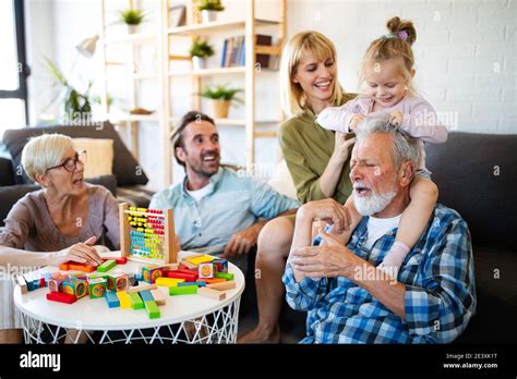 Senior Grandparents Playing With Grandchildren And Having Fun With