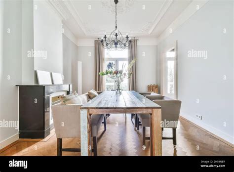 Elegant Dining Room With Large Table And Comfortable Soft Chairs Stock