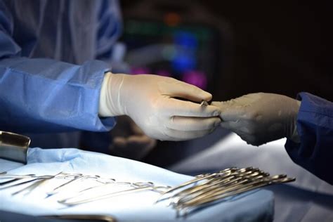 Premium Photo Midsection Of Doctors Performing Surgery On Patient In