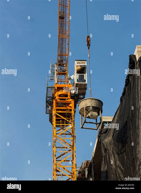 Tower Crane Lift Cement Bucket Up To Top Of Building During Construcion