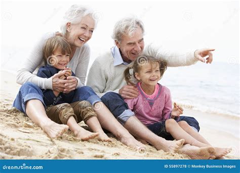 Grandparents and Grandchildren Sitting on Beach Together Stock Photo ...