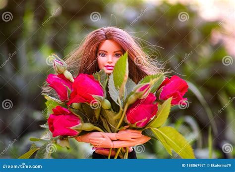 Brunette Barbie Doll With Big Bouquet Of Red Roses Outdoors Editorial