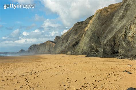 Cordoama Beach In Portugal Atlantic Ocean And Rocky Cliffs At Sandy