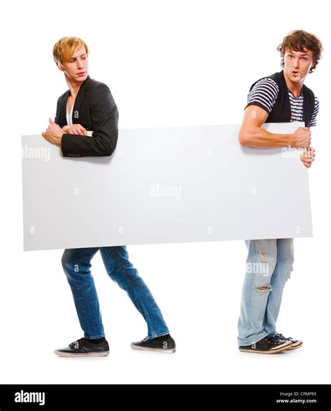 Two Modern Teenagers Holding Blank Billboard Isolated On White Stock