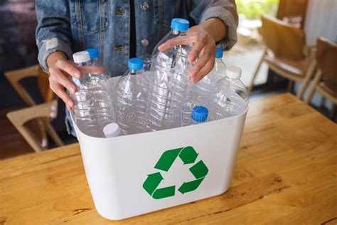 A Woman Collecting And Separating Recyclable Garbage Plastic Bottles