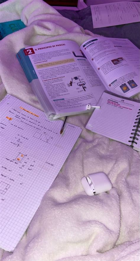 An Open Notebook Sitting On Top Of A Bed Next To A Computer Mouse