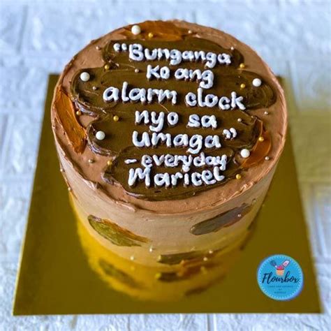 A Cake That Is On Top Of A Gold Platter With Words Written In White