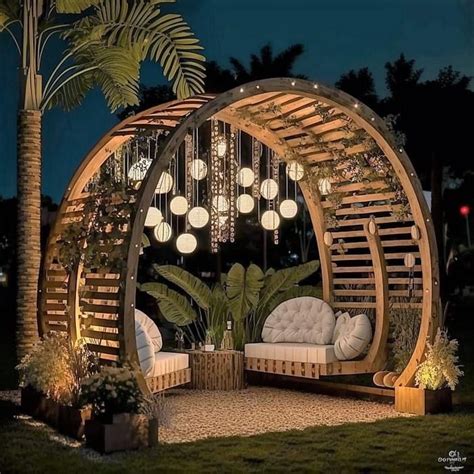 An Outdoor Seating Area Is Lit Up At Night With Lights Hanging From The