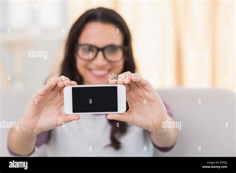 Pretty Brunette Taking A Selfie On Couch Stock Photo Alamy