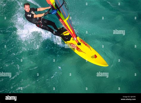 Aerial Shot Of Solo Windsurfer Sailing On Clear Emerald Green Red Sea