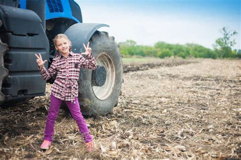 Cute Girl Near the Modern Tractor in the Field. Stock Photo - Image of cultivation, agronomics ...