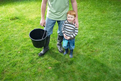 Father And Son Carrying Buckets In The Backyard Picture And Hd Photos