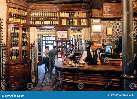 Bartender Busy At Bar Counter Of Wine Bar With Wooden Vintage