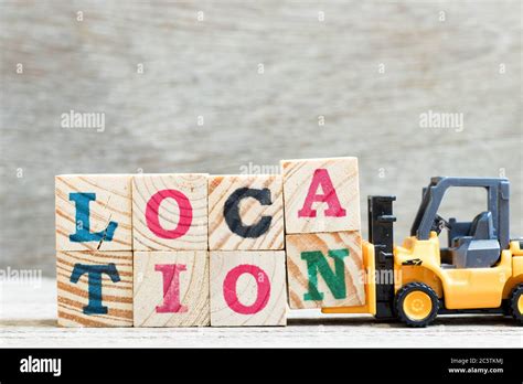 Toy Forklift Hold Letter Block A N To Complete Word Location On Wood