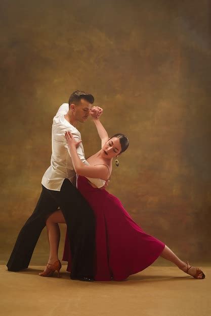 Premium Photo The Young Dance Ballroom Couple In Gold Dress Dancing