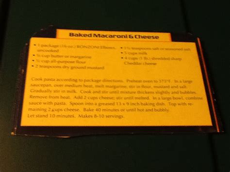The Back Side Of A Menu For Baked Macaroni And Cheese On A Table