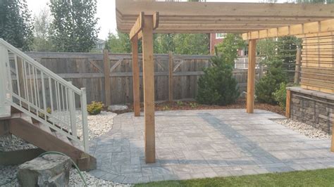 Heartland Paver Patio With A Cedar Pergola And A Rundle Stone Water