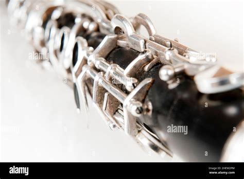 black music clarinet decorated with silver metal on white background ...