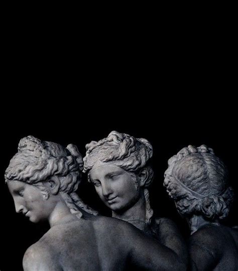 Three Statues Are Standing In The Dark With Their Backs Turned To One