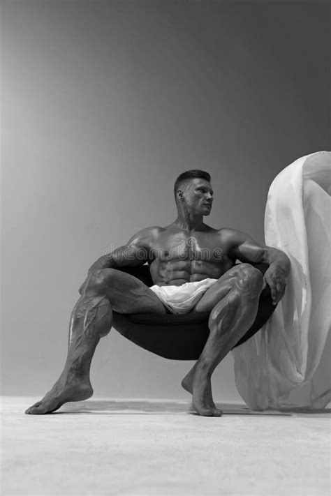 A Strong Man Of Athletic Build Sits In A Chair With A Naked Torso Stock Image Image Of Posing