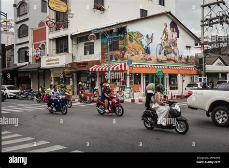 View Of Phuket Downtown In Thailand With Motorbikes And Cars On The