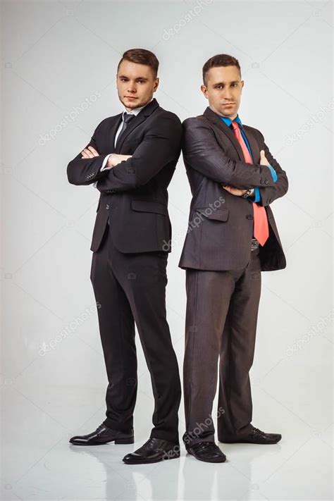 Two Business Men Standing Back To Back Isolated Stock Photo By Caps