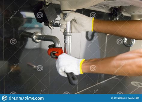 Plumber Fixing White Sink Pipe With Adjustable Wrench Stock Image