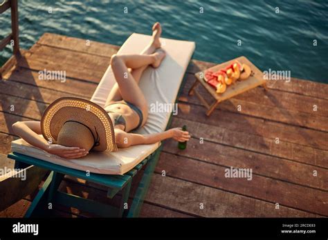 A Birds Eye View Of A Young Girl In Bikini Lying On A Sunbed And