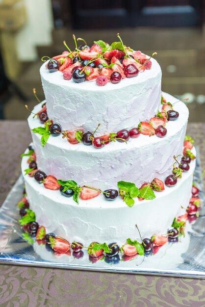 Premium Photo White Wedding Cake Decorated By Flowers Fruits