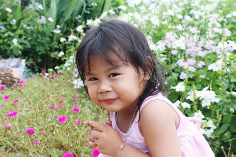 Premium Photo Portrait Of Cute Innocent Girl By Flowers