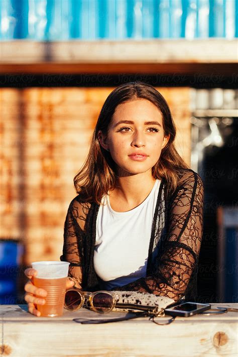 Brunette Having A Beer At Sunset By Stocksy Contributor Vero Stocksy