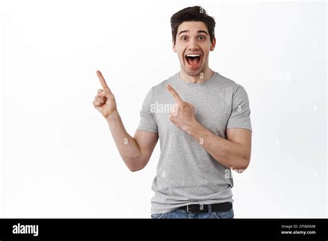 Excited Happy Guy Points Aside And Laughs Joyful Man Shows