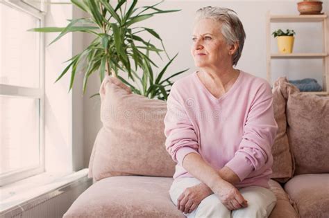 Smiling Middle Aged Mature Grey Haired Woman At Home Stock Photo