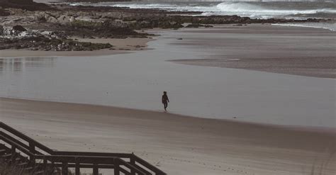 A Person Walking at a Beach · Free Stock Photo