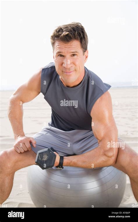 Man Beach Ball Sit Hi Res Stock Photography And Images Alamy