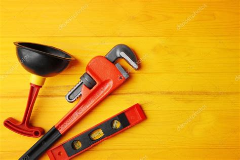 Plumber tools on yellow wooden background — Stock Photo © belchonock ...