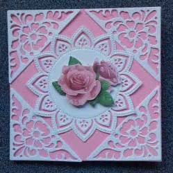 A Close Up Of A Pink Card With Flowers On The Front And Back Of It