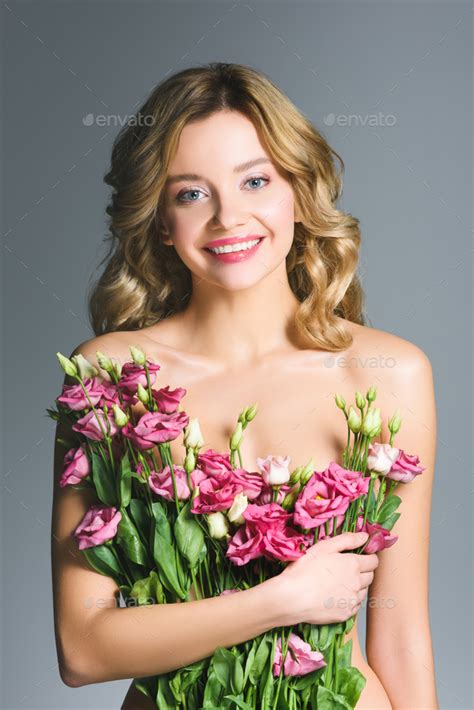 Happy Naked Woman Holding Bouquet Of Eustoma Flowers Isolated On Grey